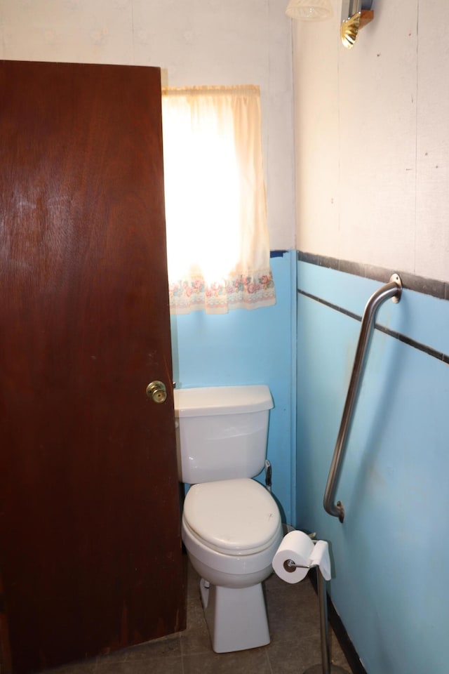 bathroom featuring toilet and tile patterned flooring