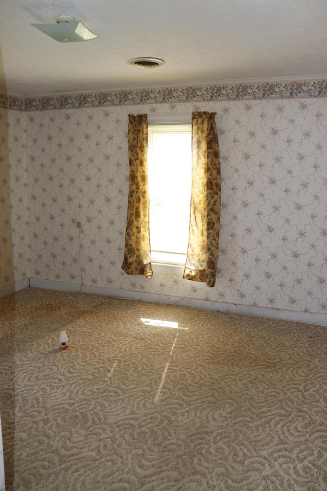 spare room featuring a textured ceiling