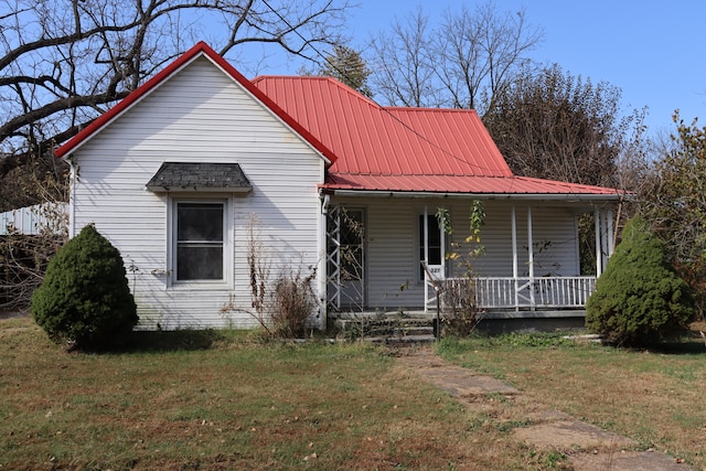 view of front of house with a porch and a front lawn