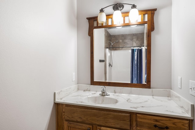 bathroom featuring vanity and curtained shower