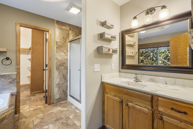 bathroom featuring plus walk in shower and vanity