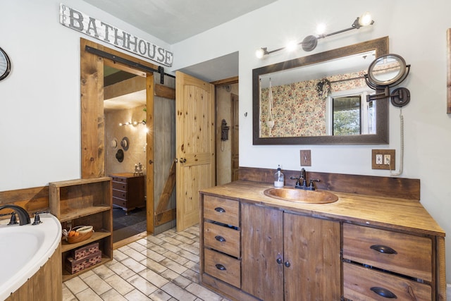 bathroom featuring vanity and a tub