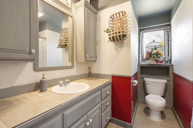 bathroom featuring vanity, toilet, and tile patterned floors