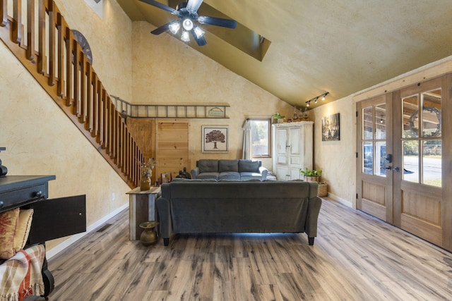 living room featuring french doors, wood-type flooring, and plenty of natural light