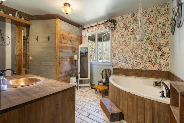 bathroom featuring vanity and a washtub