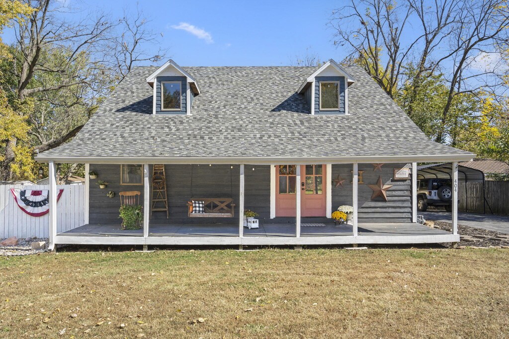 rear view of property featuring a lawn