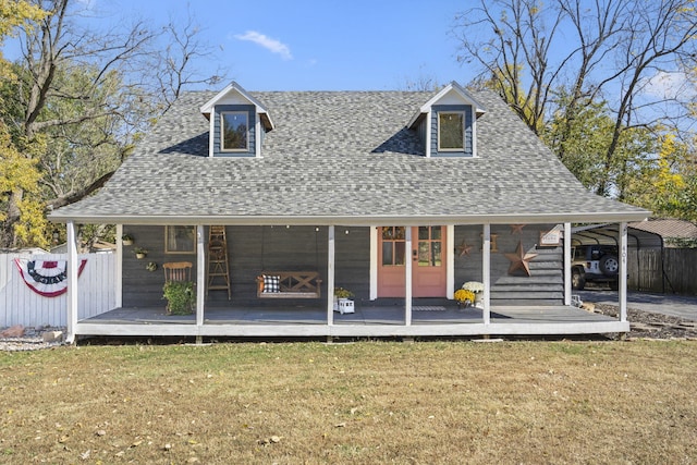 rear view of property featuring a lawn