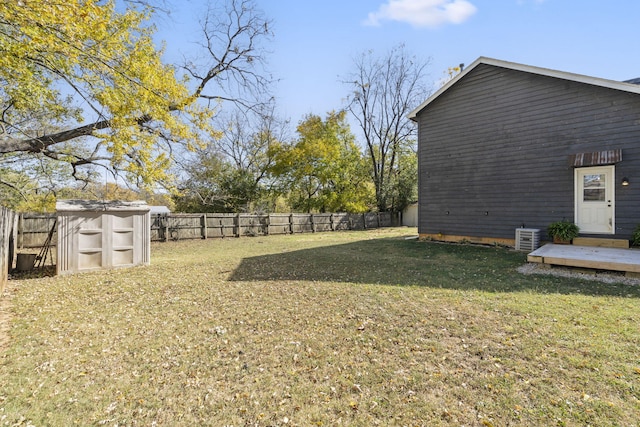 view of yard with central AC and a deck