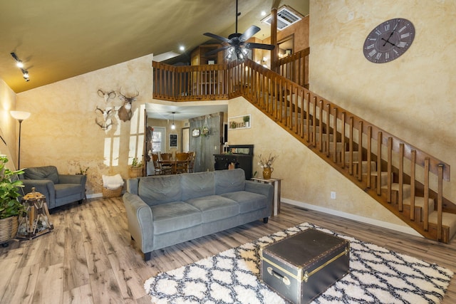 living room featuring hardwood / wood-style flooring, high vaulted ceiling, and ceiling fan