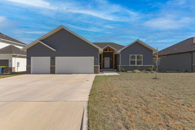 view of front of property with a front yard and a garage