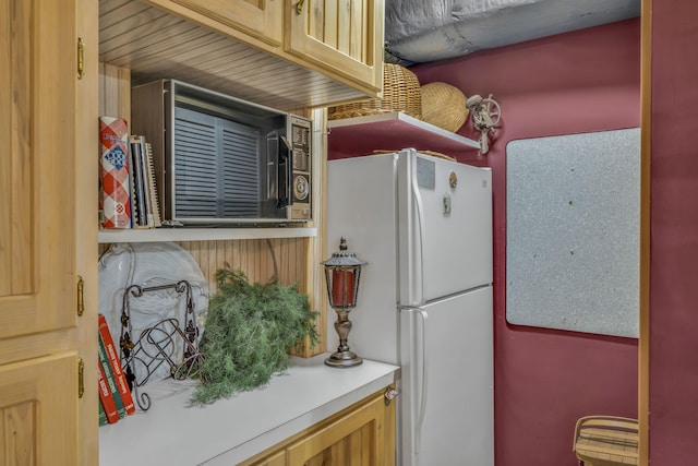 kitchen featuring white fridge and light brown cabinetry