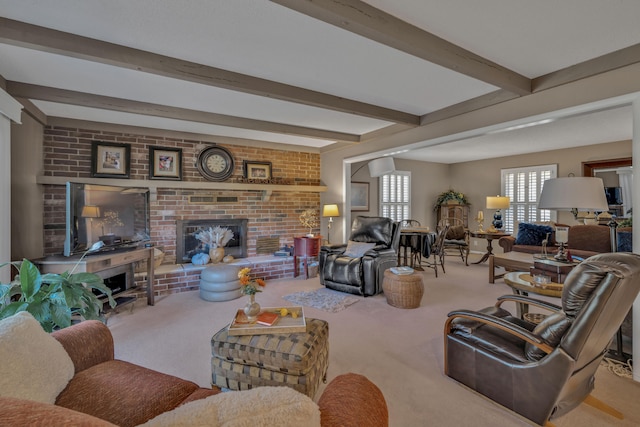 carpeted living room featuring beam ceiling and a brick fireplace