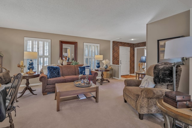 living room with a textured ceiling and light colored carpet