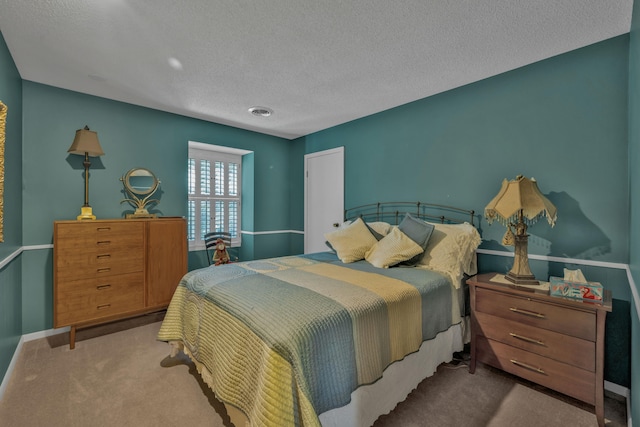 bedroom with a textured ceiling and carpet floors