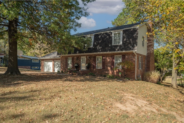 view of front of house featuring a front yard and a garage