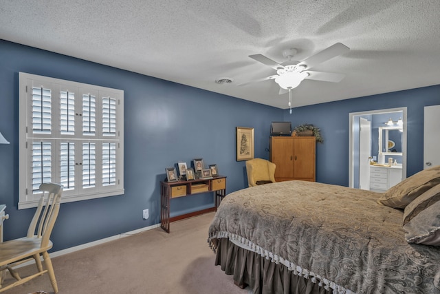 bedroom featuring connected bathroom, ceiling fan, carpet flooring, and a textured ceiling