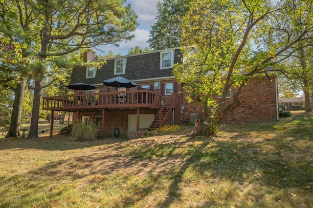 rear view of house with a yard, a deck, and central AC