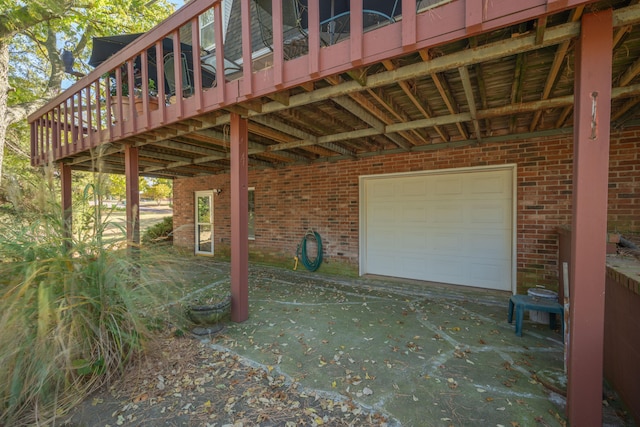 view of patio with a wooden deck and a garage