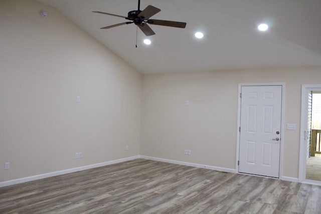 spare room with lofted ceiling, ceiling fan, baseboards, recessed lighting, and wood finished floors