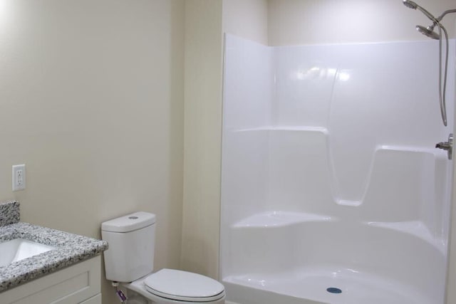 full bathroom with a shower, vanity, and toilet