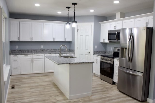 146 Mound St, Forsyth, MO 65653 - kitchen with recessed lighting, hanging light fixtures, stainless steel appliances, a sink, and white cabinetry
