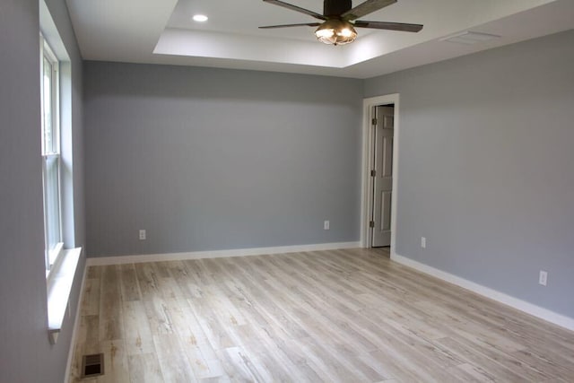 146 Mound St, Forsyth, MO 65653 - unfurnished room with recessed lighting, light wood-style floors, ceiling fan, baseboards, and a tray ceiling