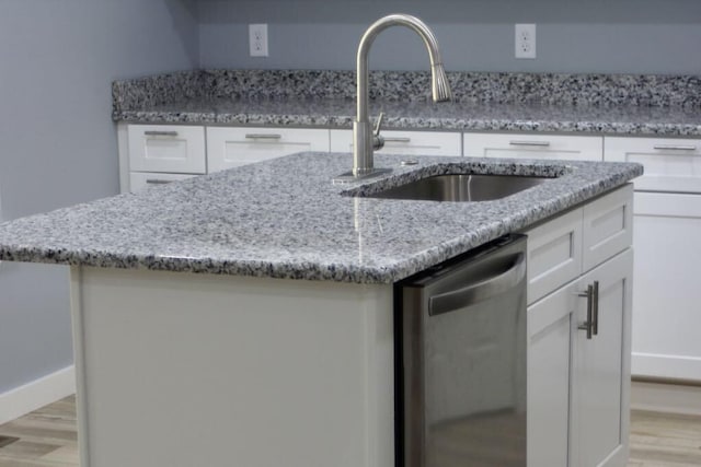 146 Mound St, Forsyth, MO 65653 - kitchen featuring light stone counters, white cabinets, a sink, light wood-type flooring, and dishwasher