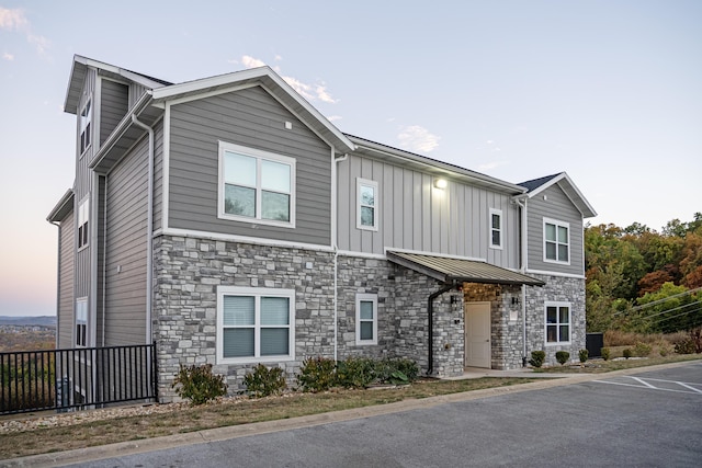 view of front of home featuring stone siding and board and batten siding