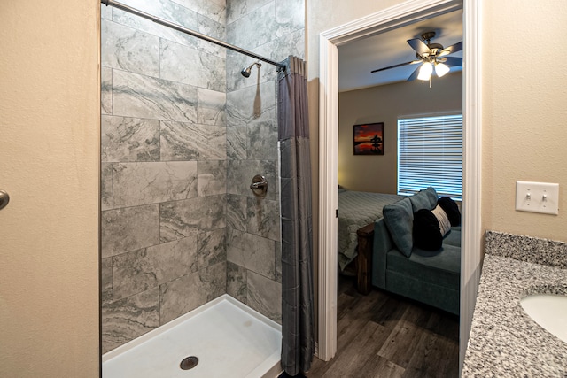 bathroom featuring vanity, hardwood / wood-style floors, ceiling fan, and walk in shower