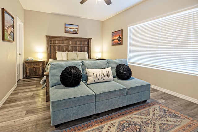 bedroom with baseboards, a ceiling fan, and wood finished floors