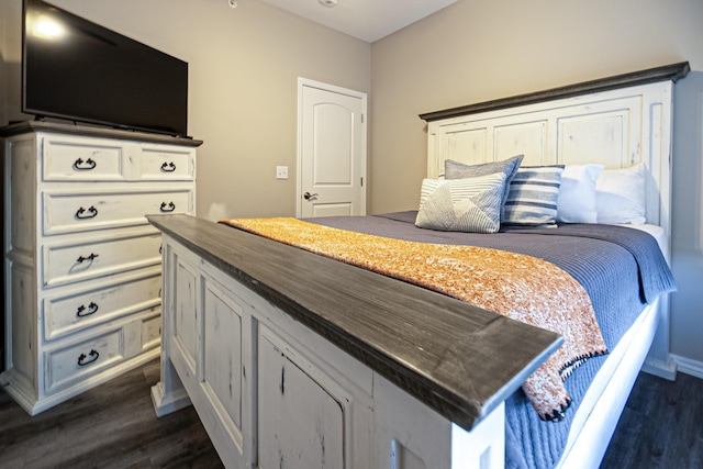bedroom with dark wood-type flooring