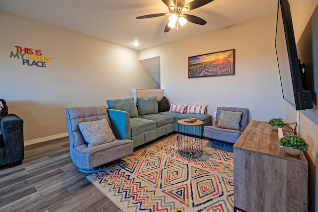 living room with dark hardwood / wood-style floors and ceiling fan