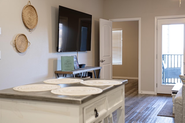 dining area featuring dark wood finished floors, a wealth of natural light, and baseboards