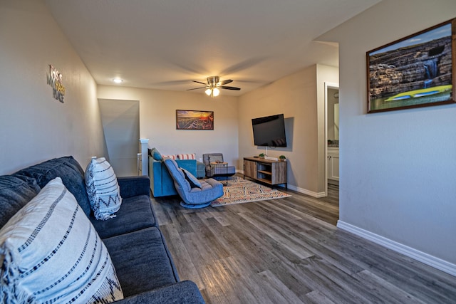 living room with wood finished floors, baseboards, and ceiling fan