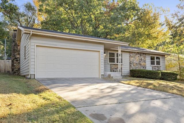 single story home with a front yard and a garage