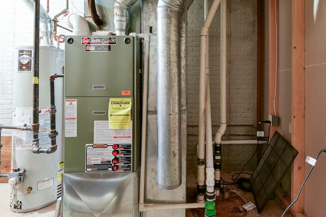 utility room featuring gas water heater