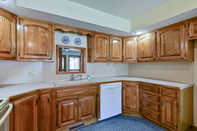 kitchen featuring sink, a textured ceiling, and white appliances