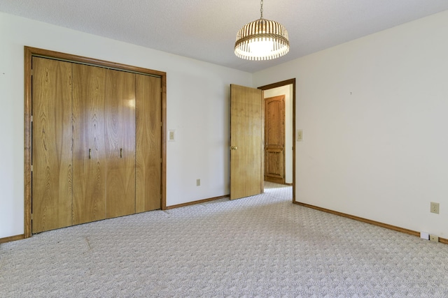 1462 E Powell St, Springfield, MO 65804 - unfurnished bedroom with carpet, a closet, baseboards, and a chandelier