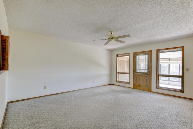 1462 E Powell St, Springfield, MO 65804 - spare room featuring light carpet, a ceiling fan, baseboards, and a textured ceiling
