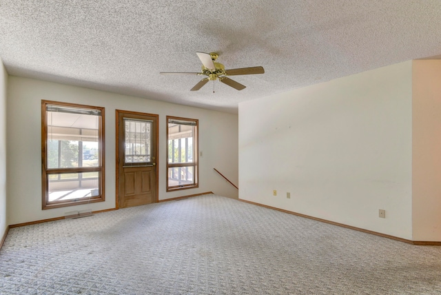 interior space featuring carpet, a textured ceiling, and ceiling fan