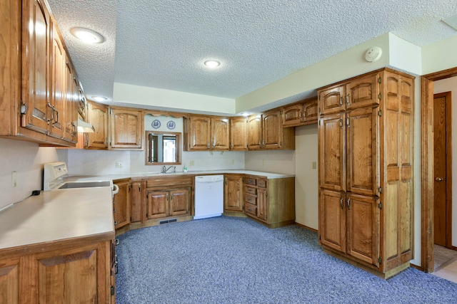 kitchen featuring dishwasher, a textured ceiling, and light colored carpet