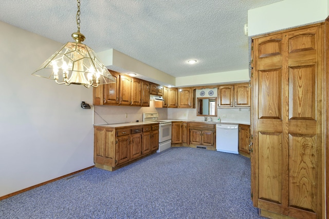 kitchen with dark carpet, a chandelier, decorative light fixtures, and white appliances