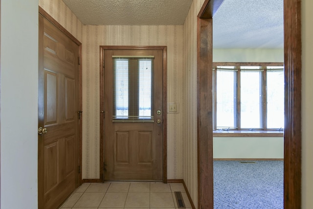 1462 E Powell St, Springfield, MO 65804 - entryway with wallpapered walls, a textured ceiling, baseboards, and light tile patterned flooring