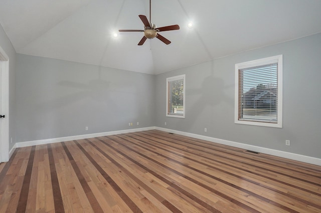 spare room featuring hardwood / wood-style flooring, high vaulted ceiling, and ceiling fan