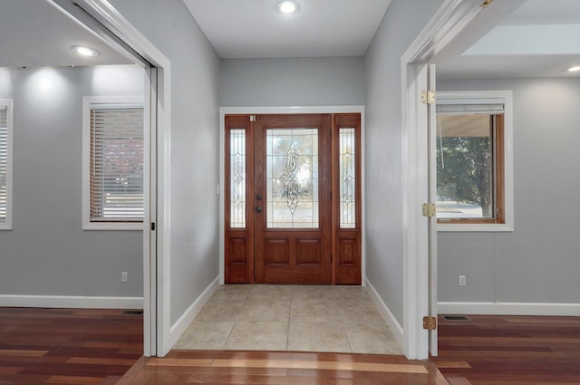 foyer entrance with light hardwood / wood-style floors