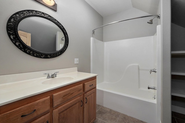 bathroom with vanity, tub / shower combination, vaulted ceiling, and tile patterned floors