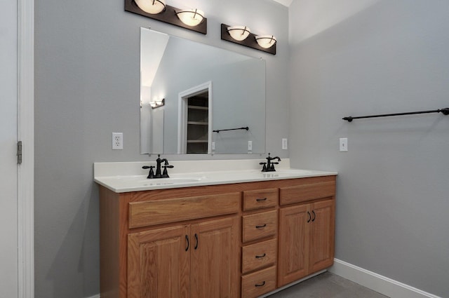 bathroom featuring vanity and lofted ceiling