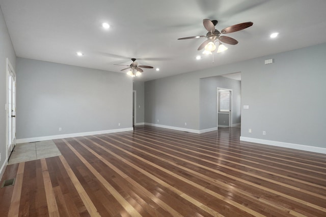 spare room featuring ceiling fan and dark hardwood / wood-style flooring