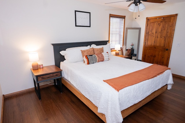 bedroom with dark wood-type flooring and ceiling fan