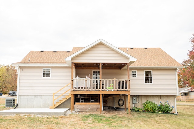 rear view of house with a deck and a lawn